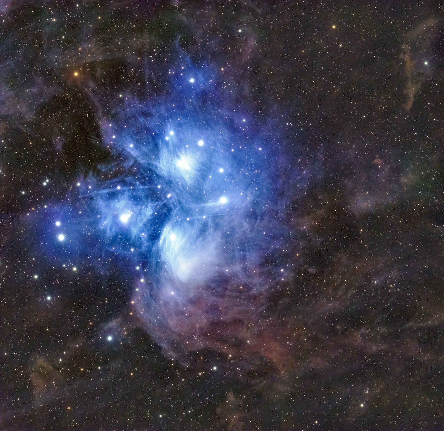Blue and purple gas clouds and dust in a colorful nebula.