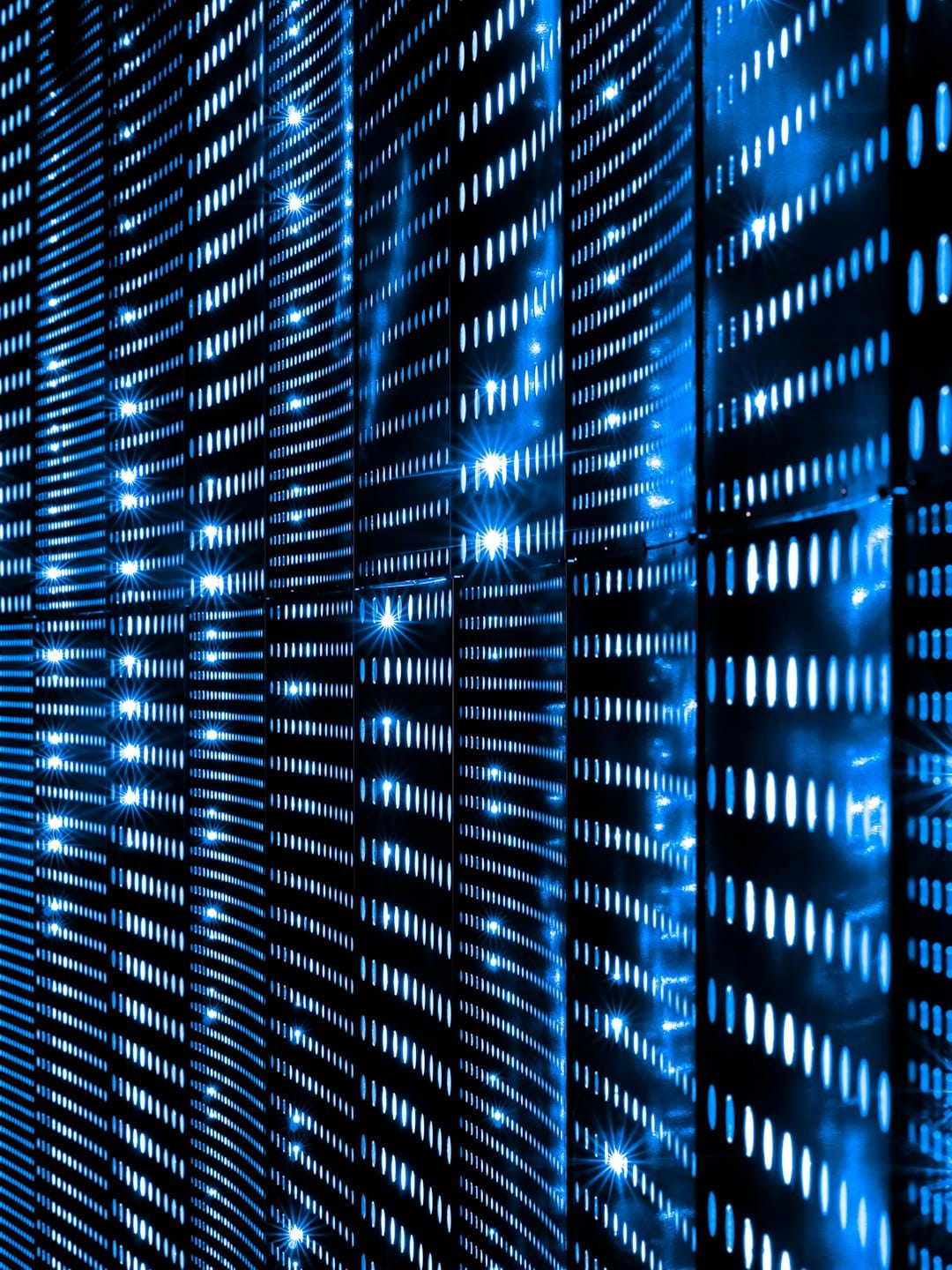 Abstract blue lights on a dark technological grid surface.