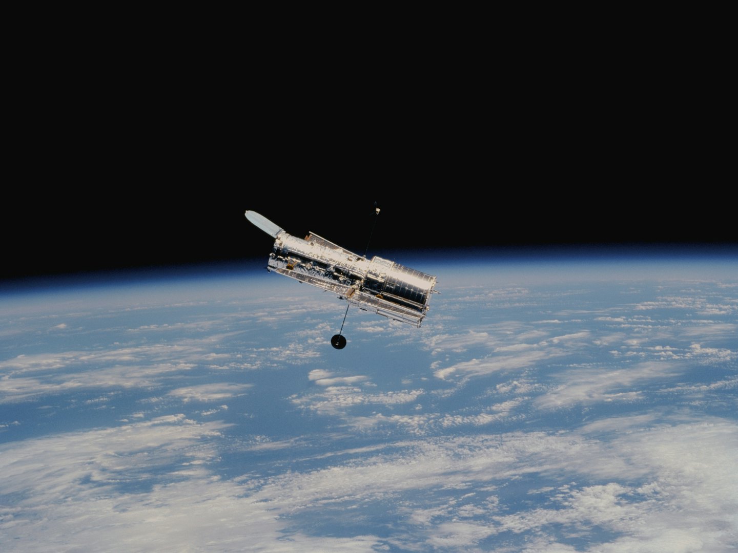 The Hubble Space Telescope orbits above the Earth.